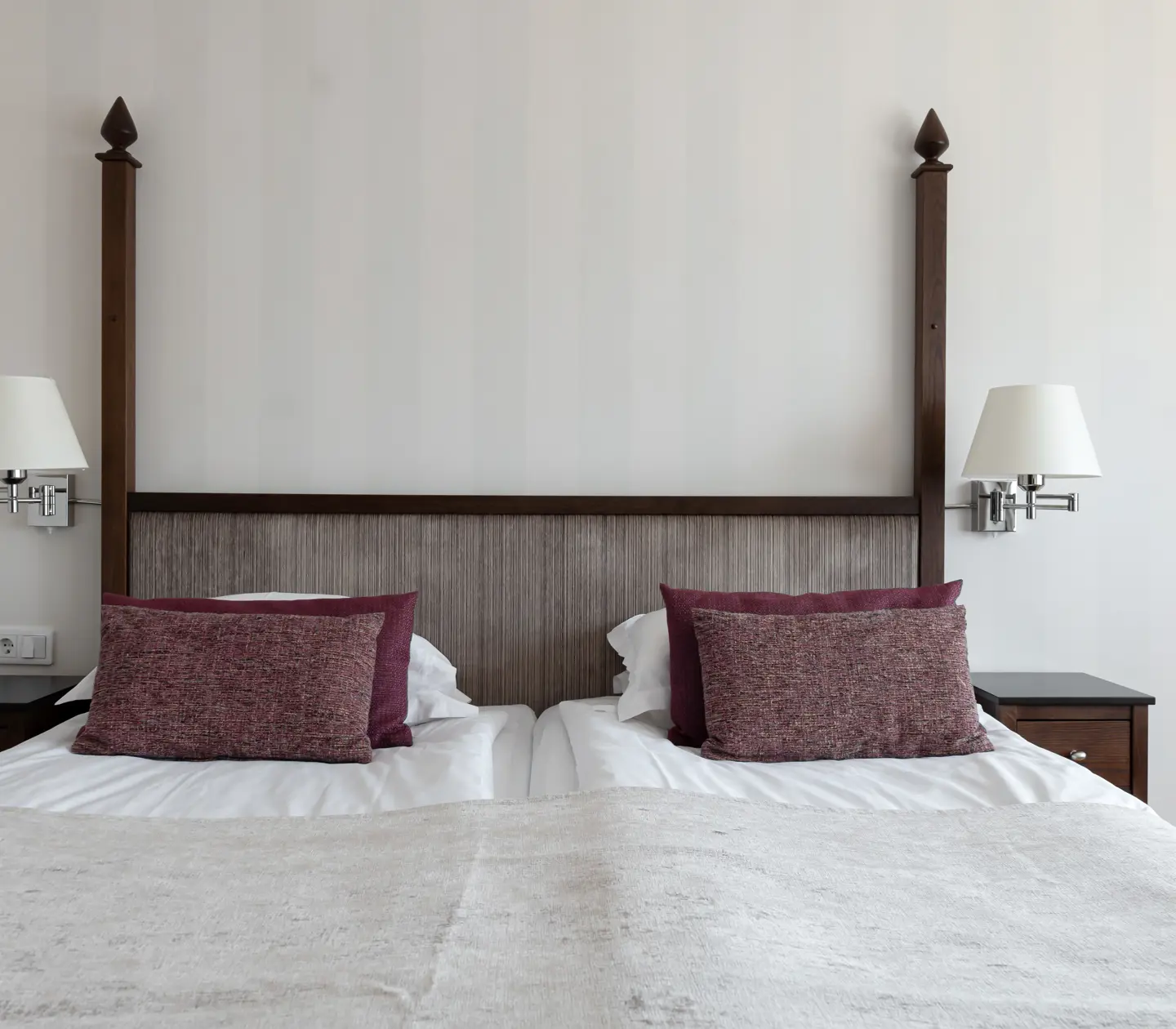 Bright hotel room with double bed, bedside table and bedside lamps