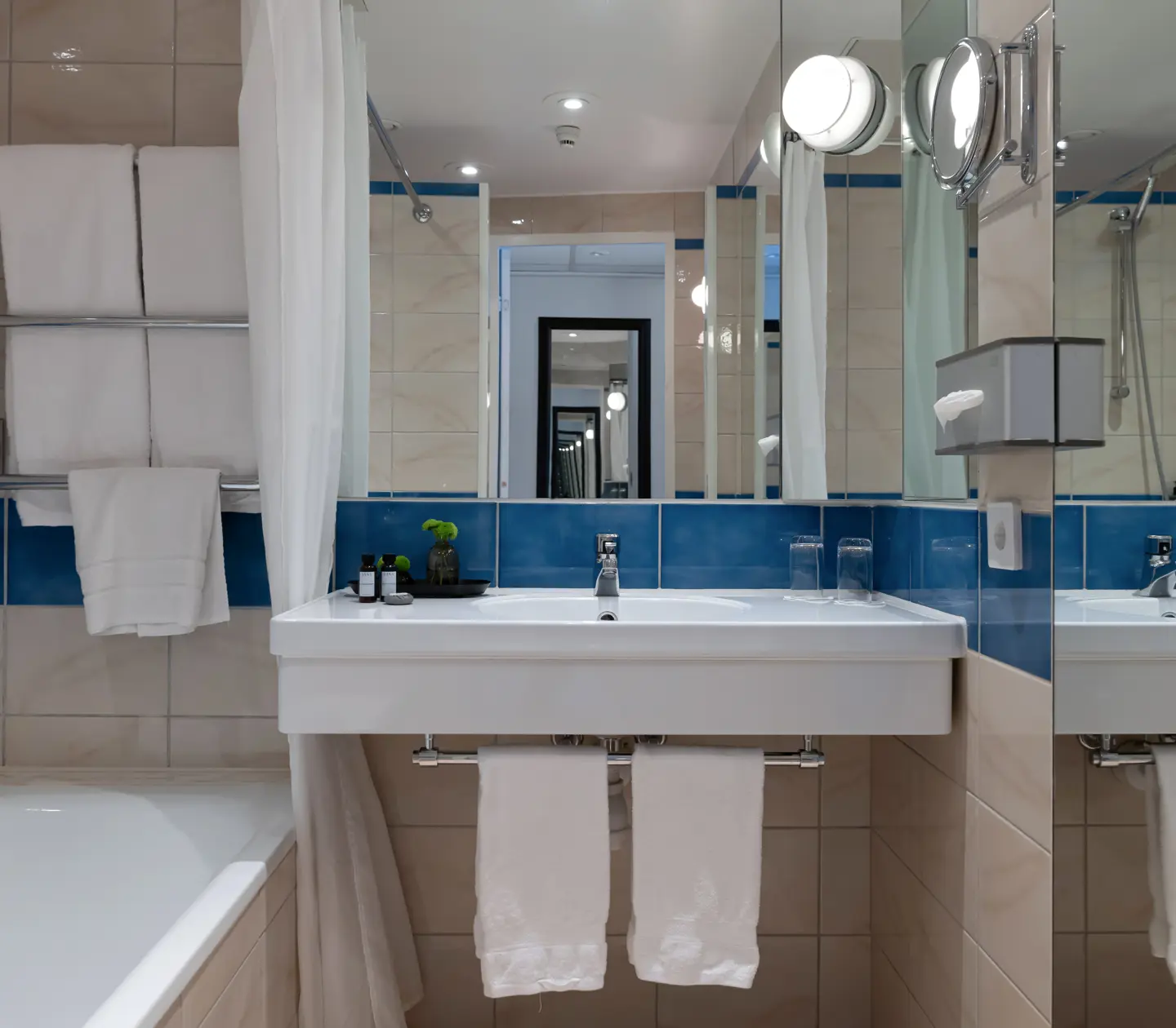 Beige bathroom with sink, mirror and bathtub