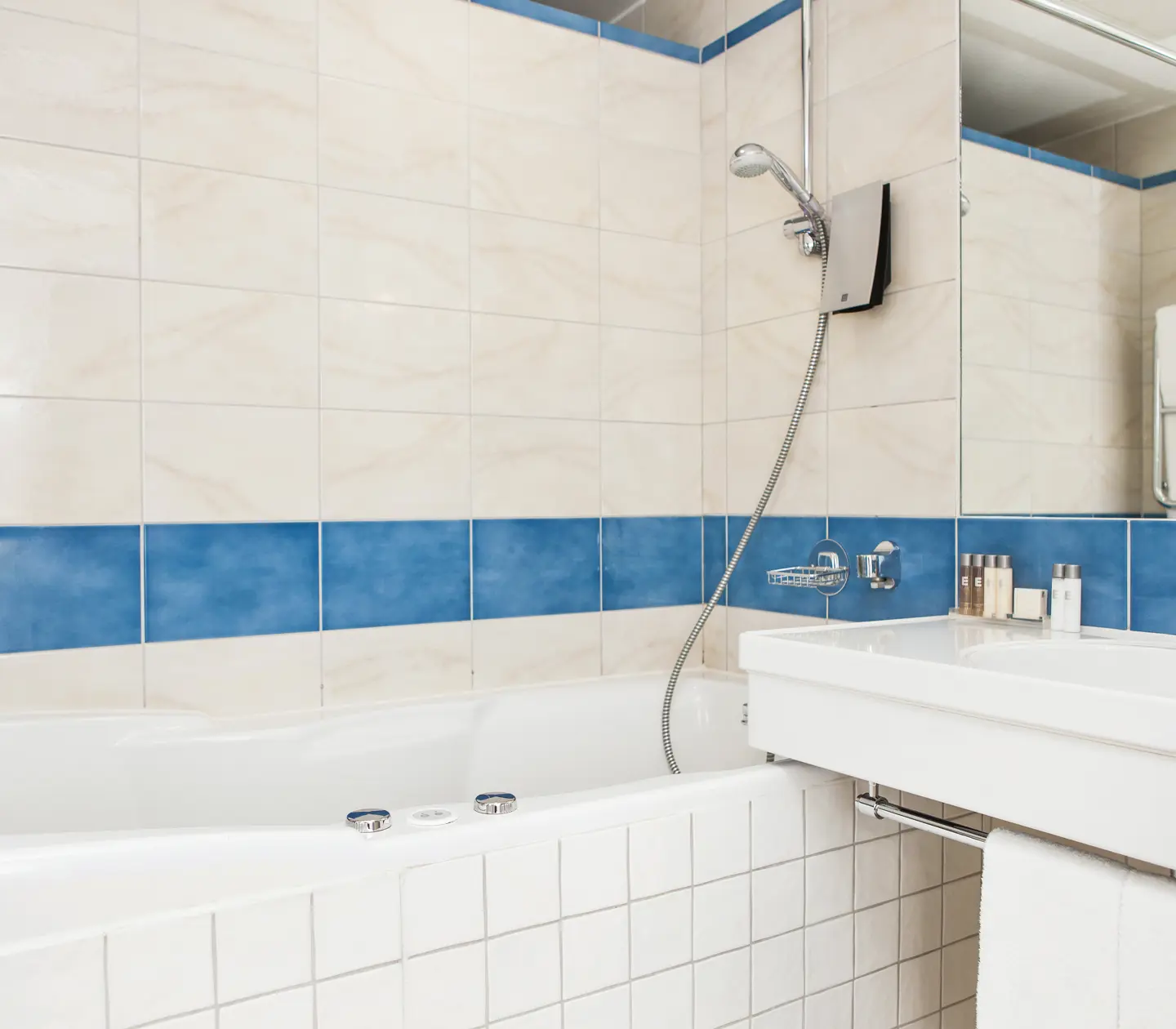 Bright bathroom with sink, mirror and bathtub