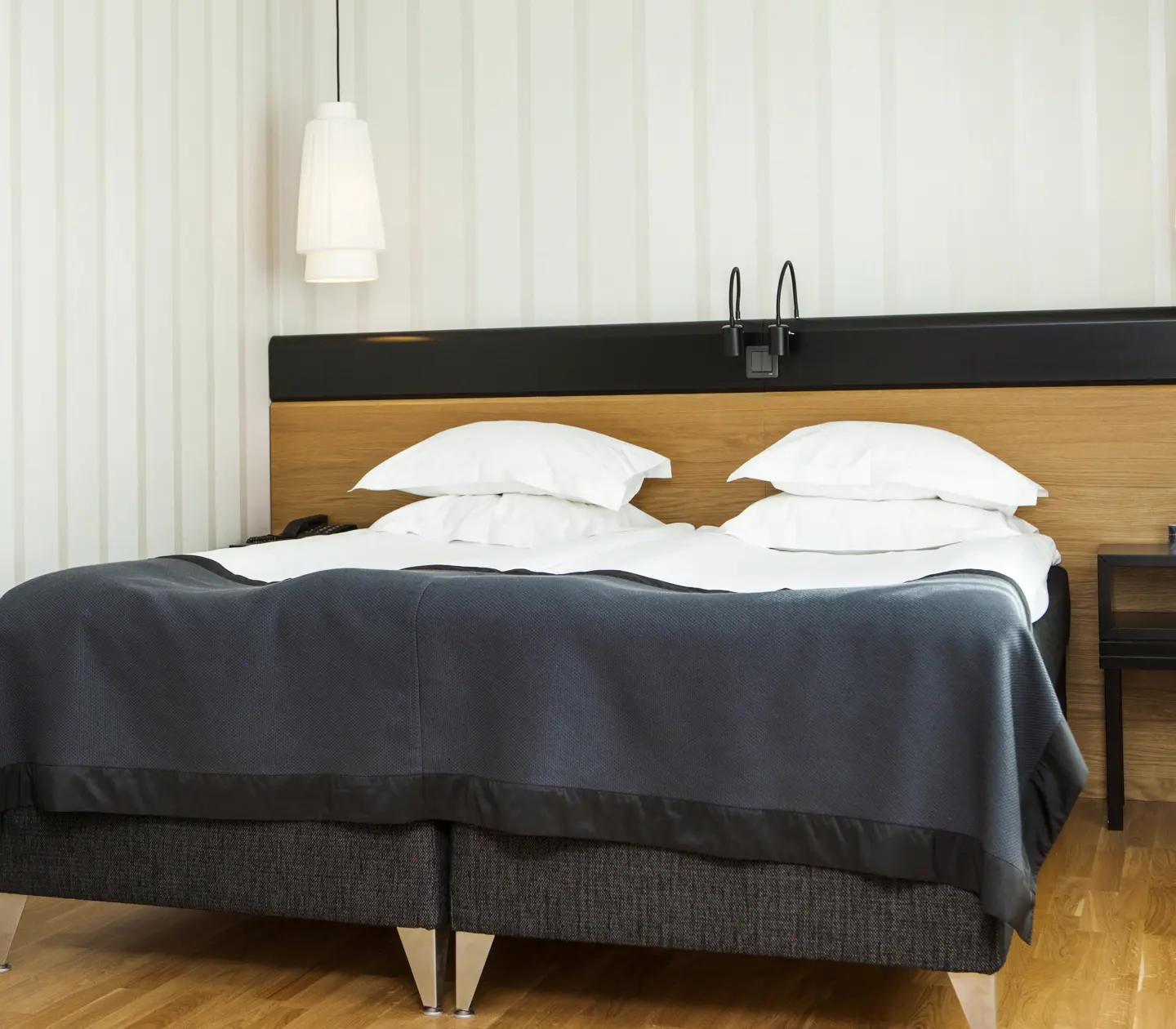 Hotel suite with bed and bedside lamps