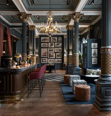Cozy hotel environment with seating, bar counter and paintings