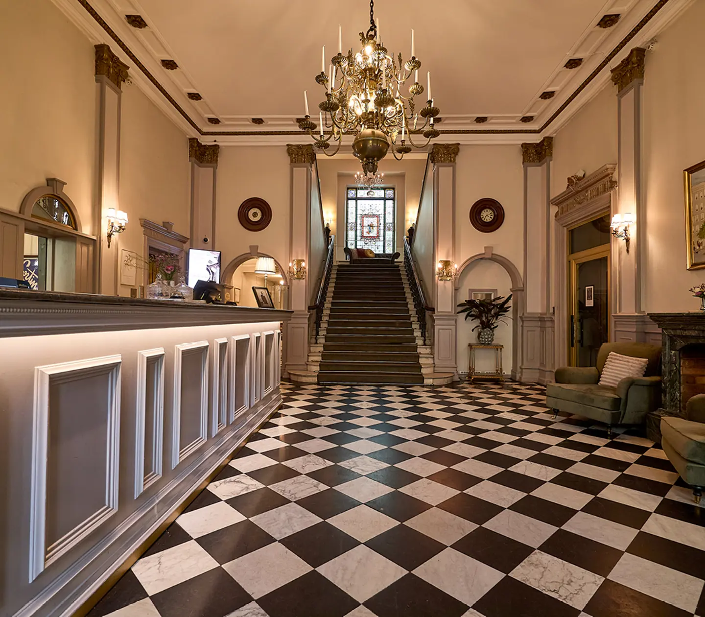 Hotel lobby with checkerboard floor and stairs