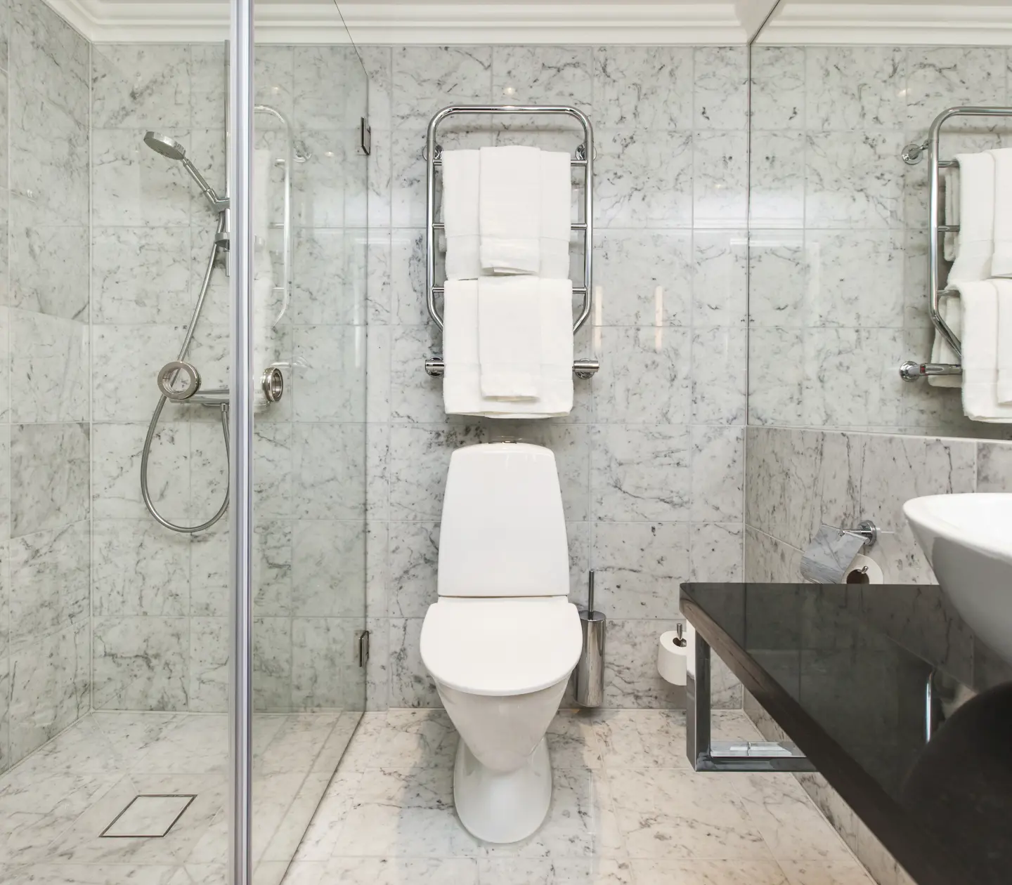 Bright bathroom with sink, toilet and shower