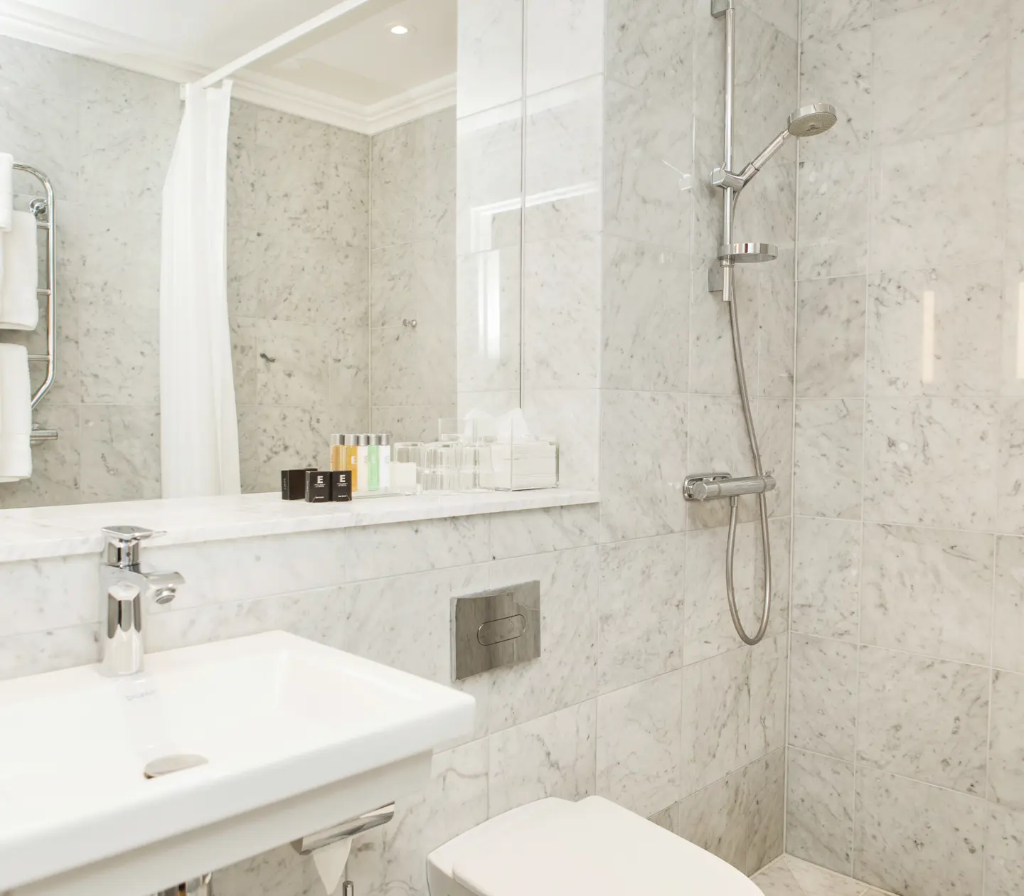 Bright bathroom with sink, toilet and shower