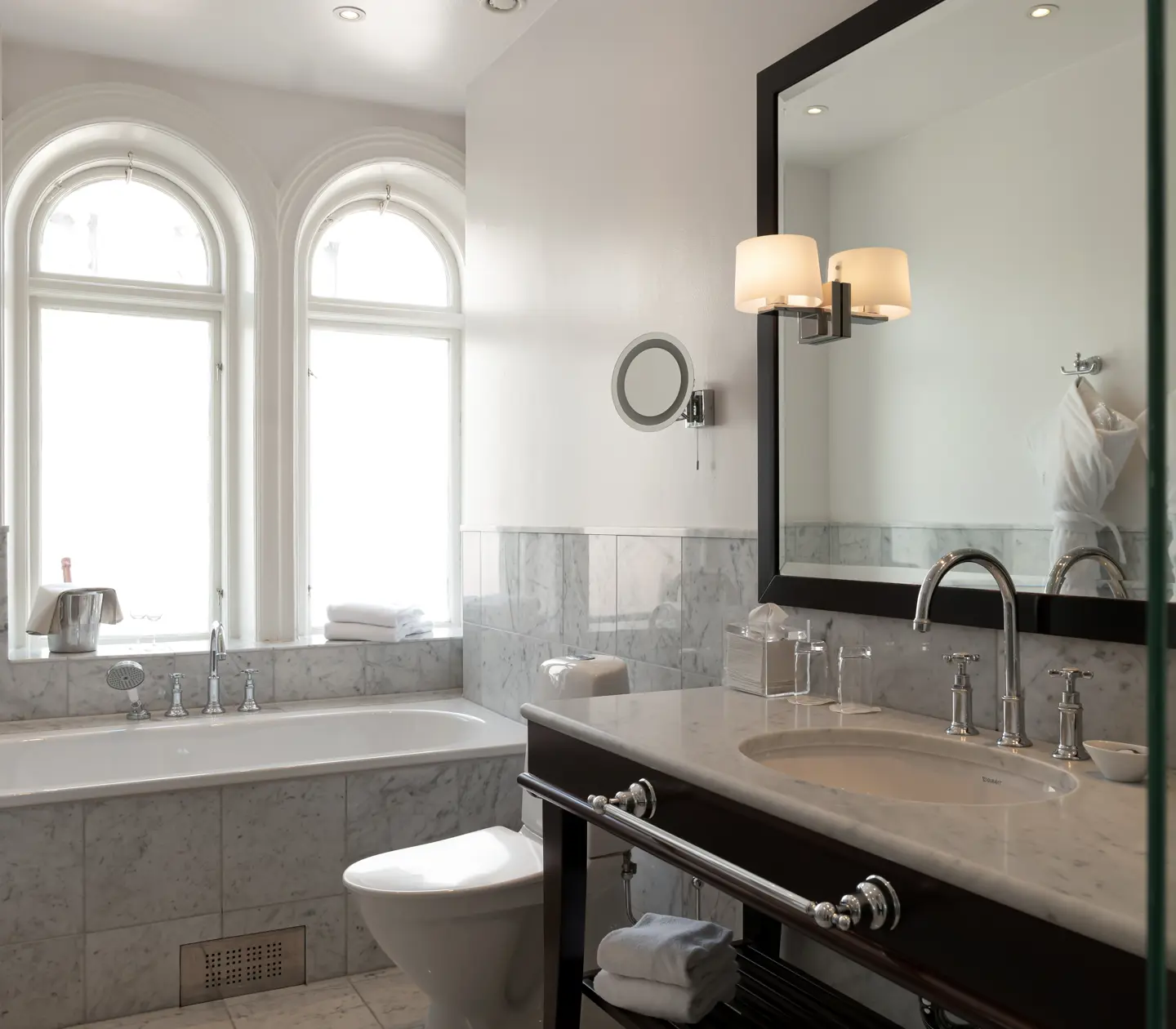 Bright bathroom with sink, window and bathtub