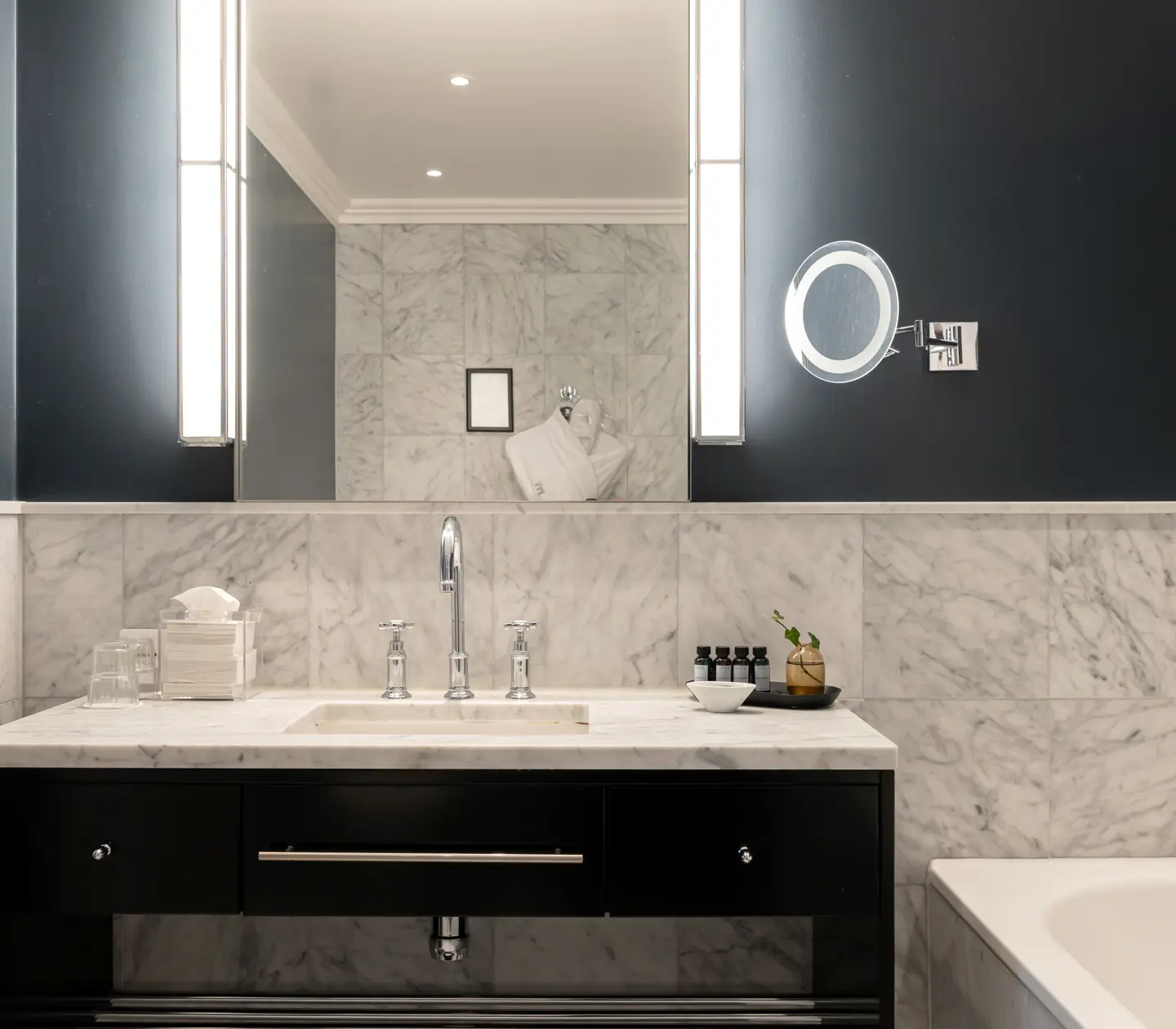 Bright bathroom with sink, mirror and bathtub