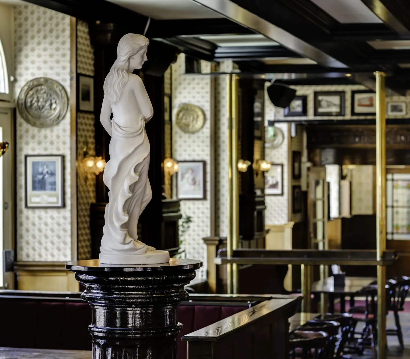 Pub with seating areas and statues