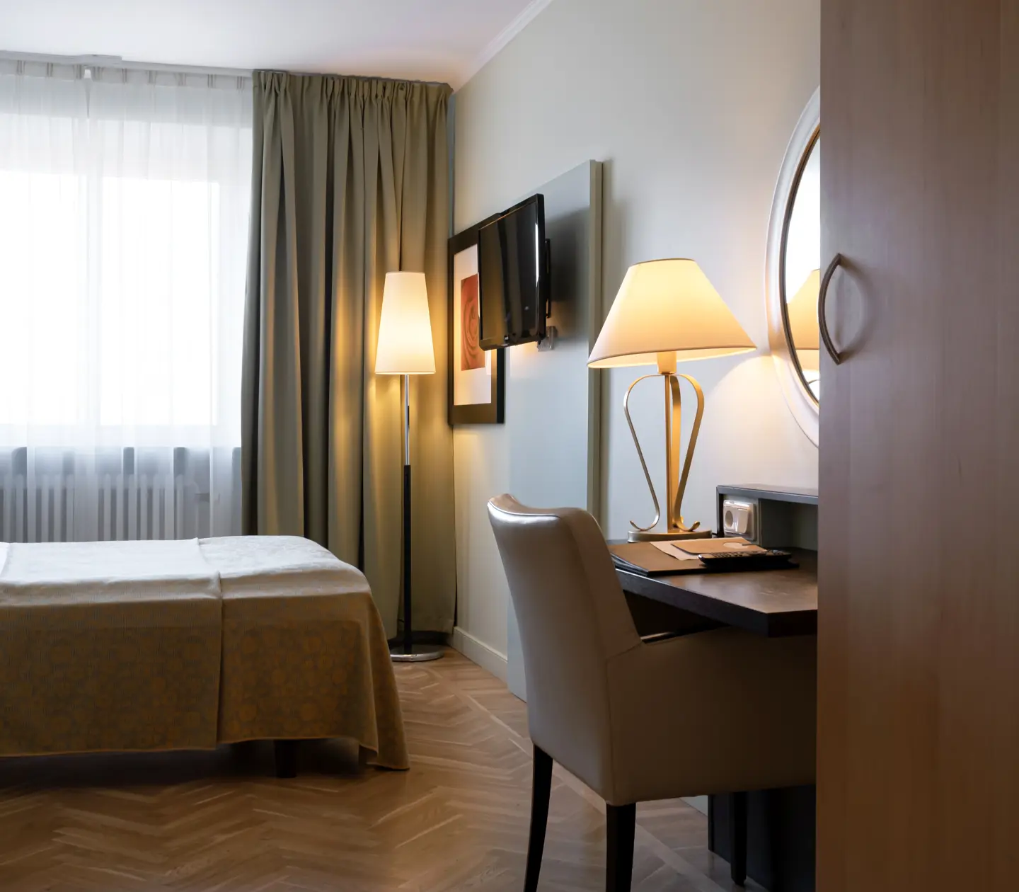 Hotel room with bed, desk and window