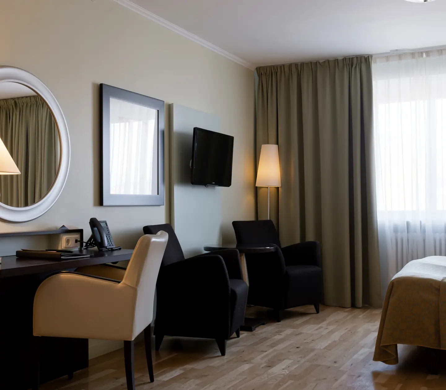 Hotel room with desk, armchairs and window