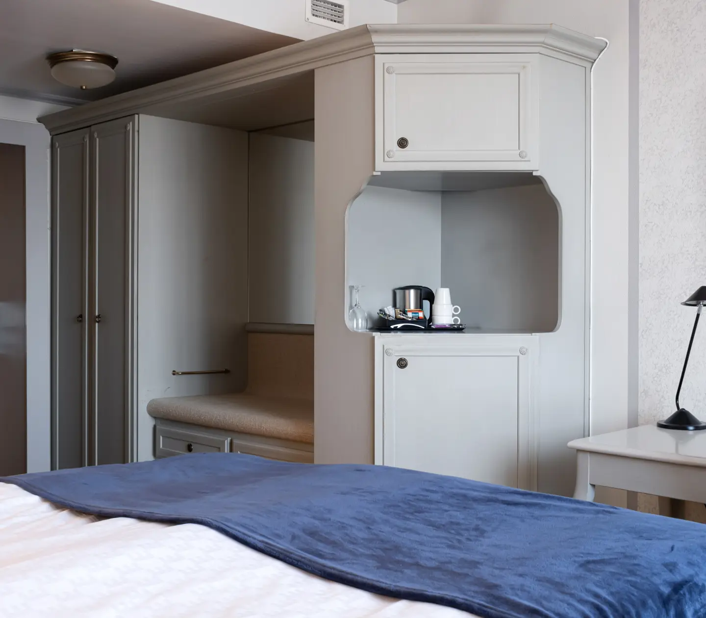 Hotel room with bed, wardrobe and desk
