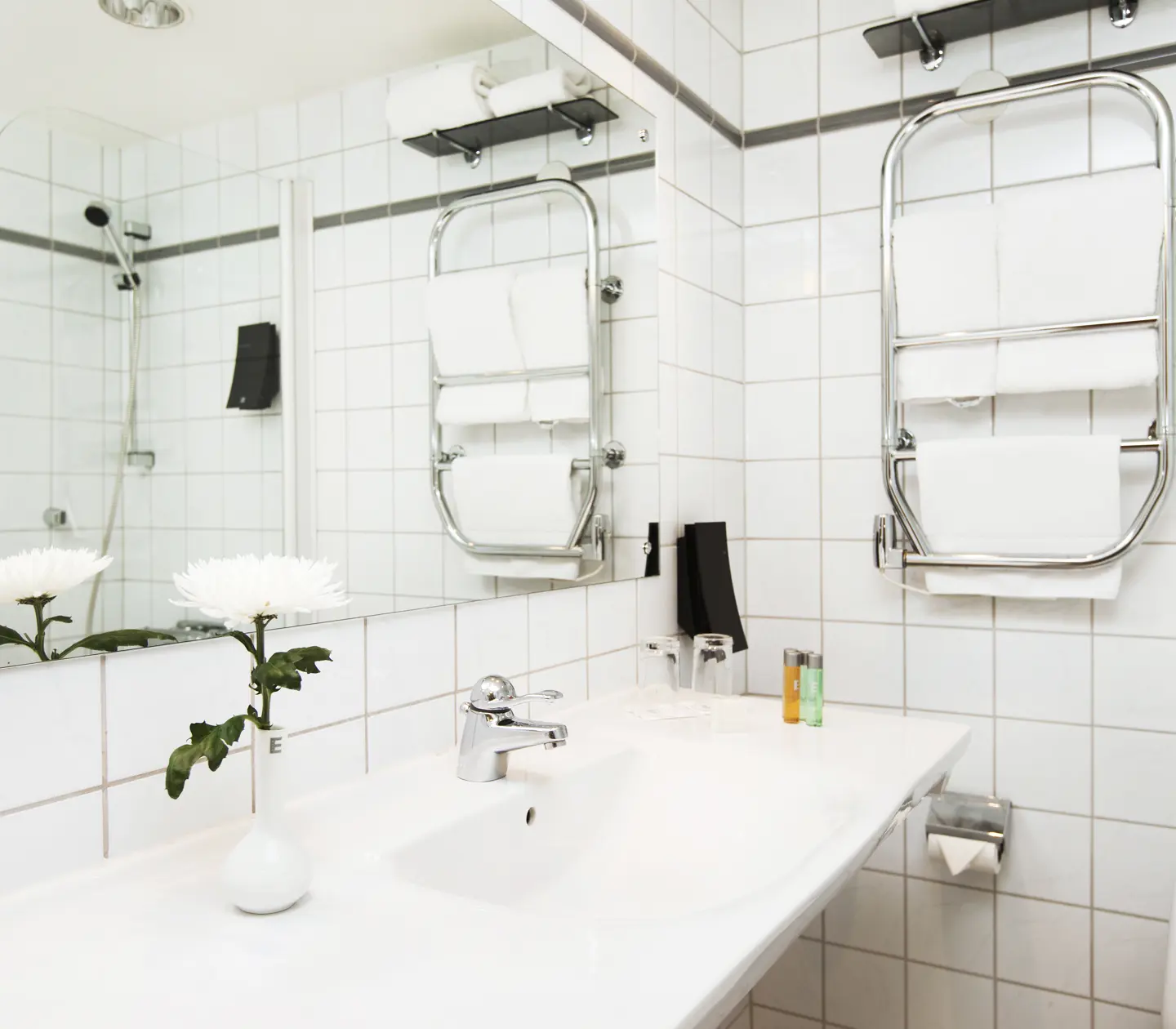 Bright bathroom with sink, mirror and toilet