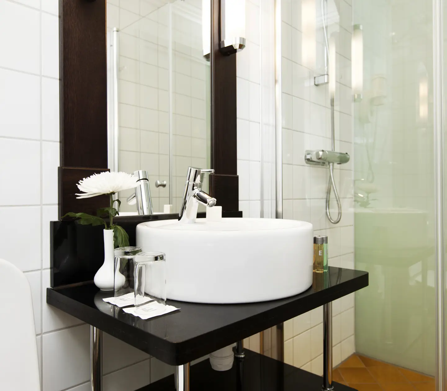Bright bathroom with sink, mirror and shower