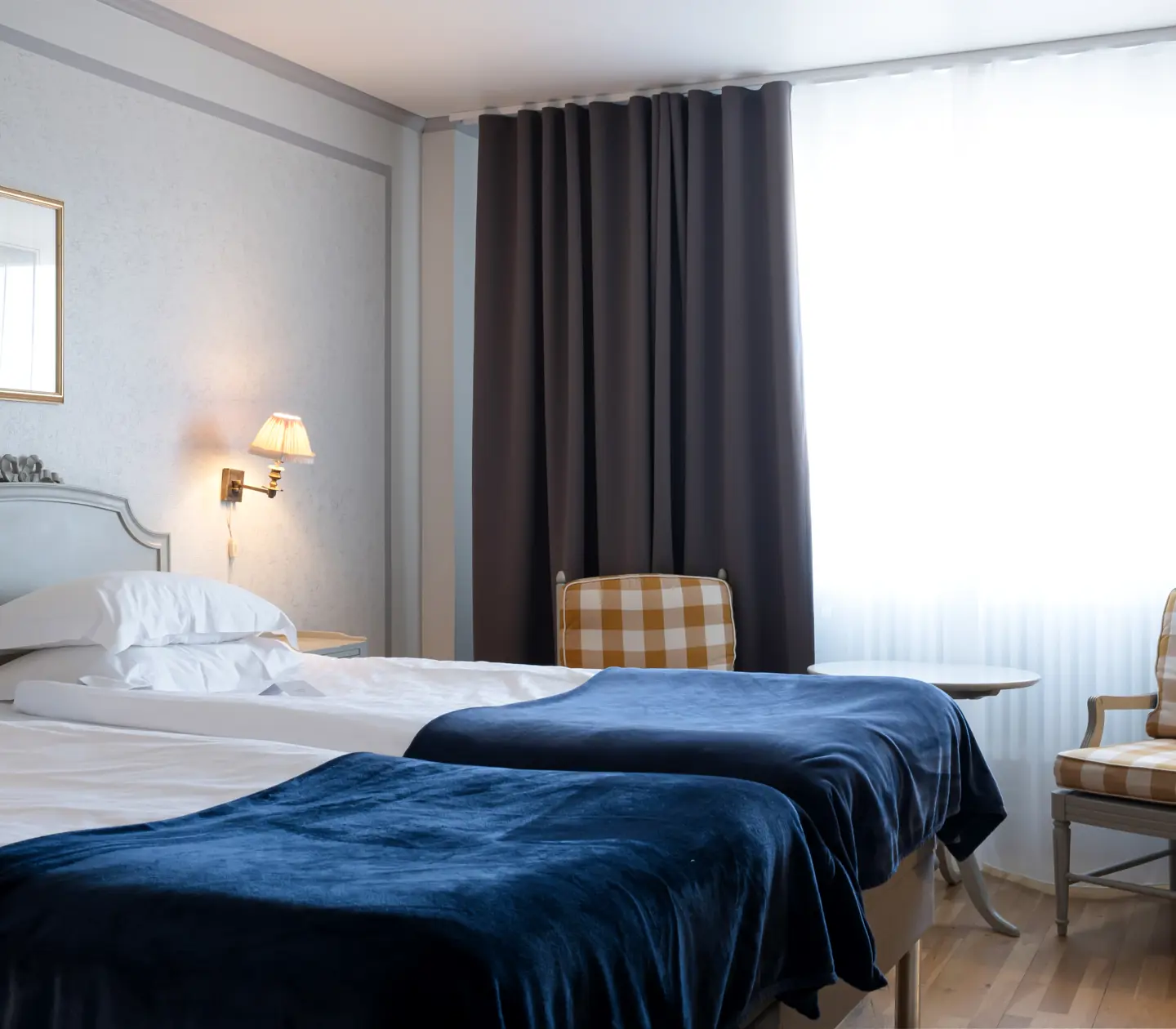 Hotel room with bed, armchairs and window
