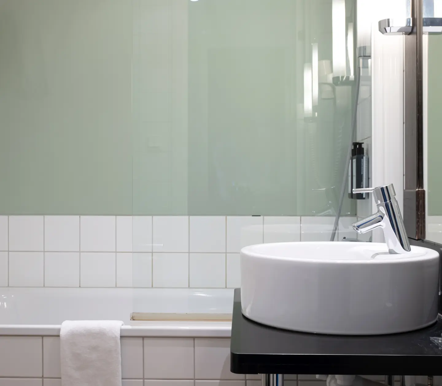 Bright bathroom with sink, mirror and bathtub