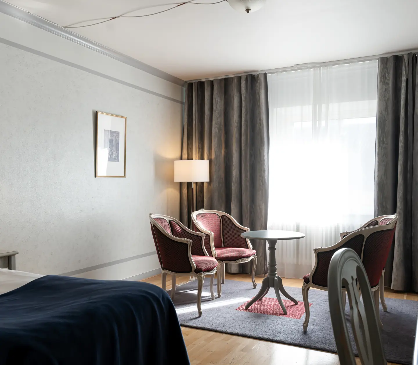 Hotel room with bed, sitting area and window