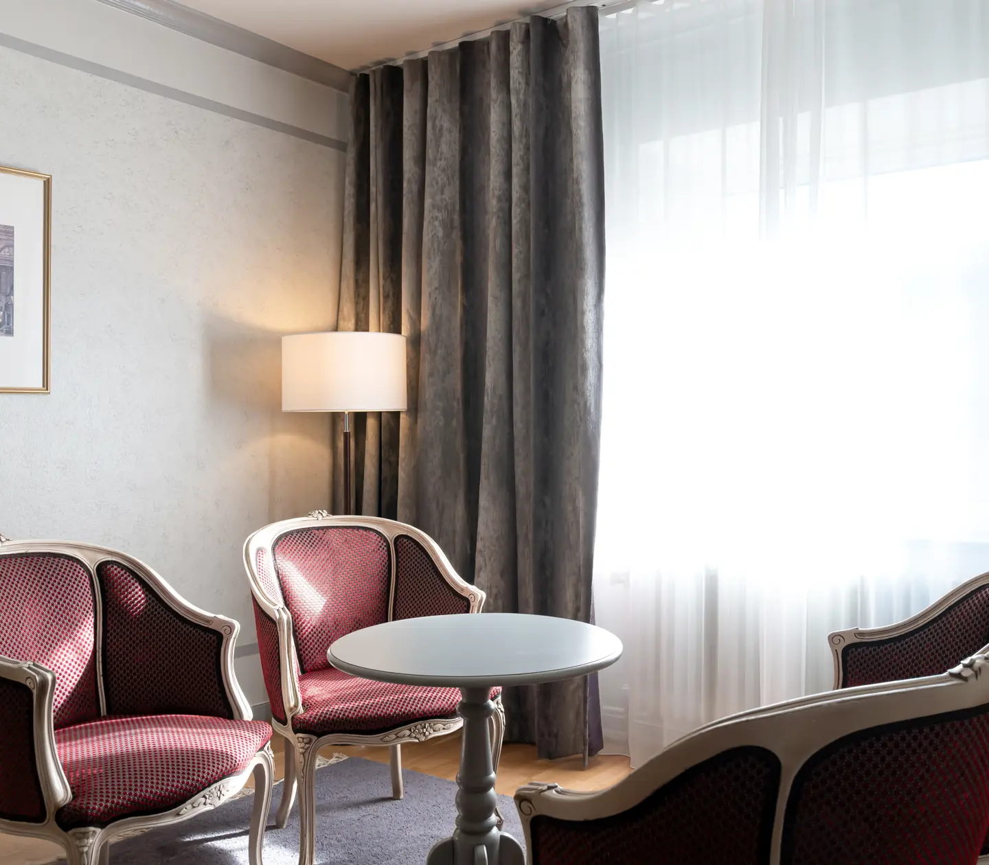 Hotel room with sitting area, blackboard and window