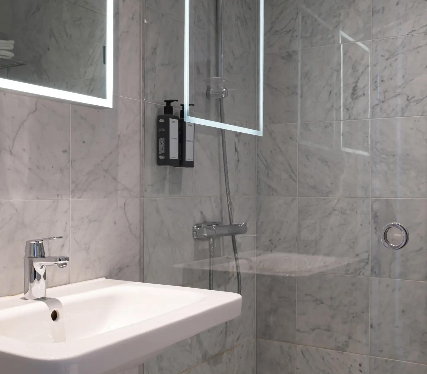 Bright bathroom with sink, mirror and shower