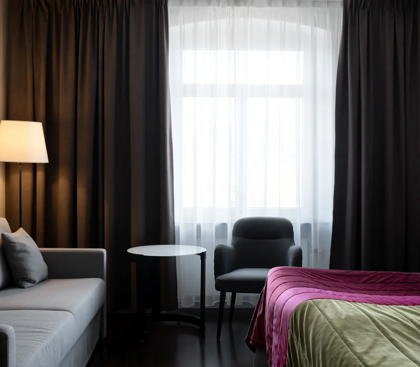 Hotel room with bed, sofa and window