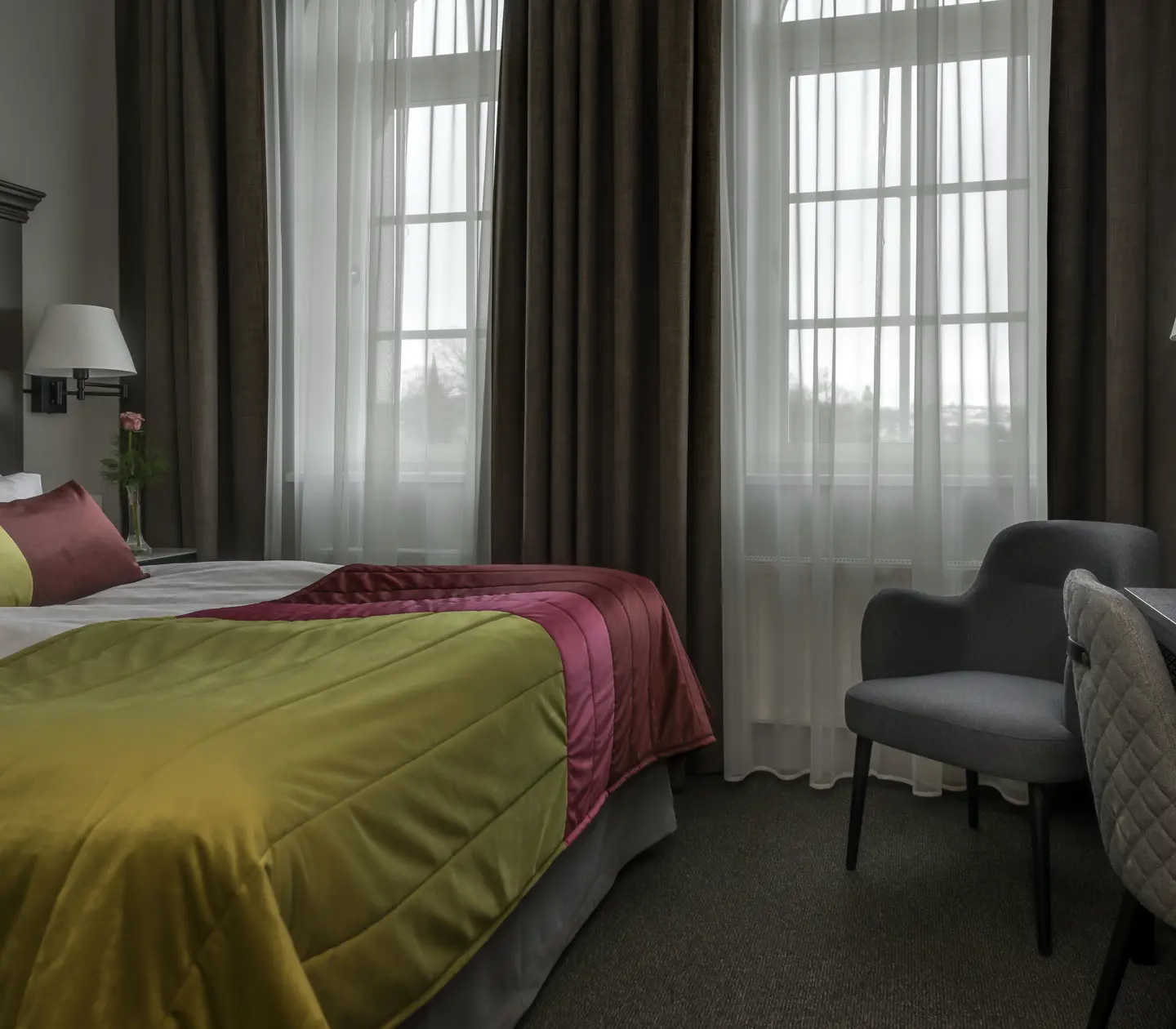 Hotel room with bed, large wooden headboard and window
