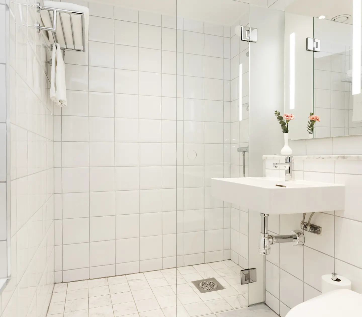 Bright bathroom with sink, mirror and shower