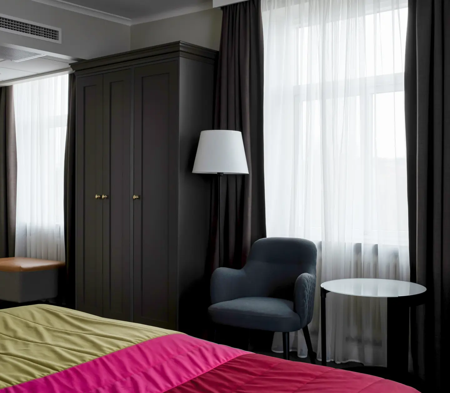 Hotel room with bed, wardrobe and window