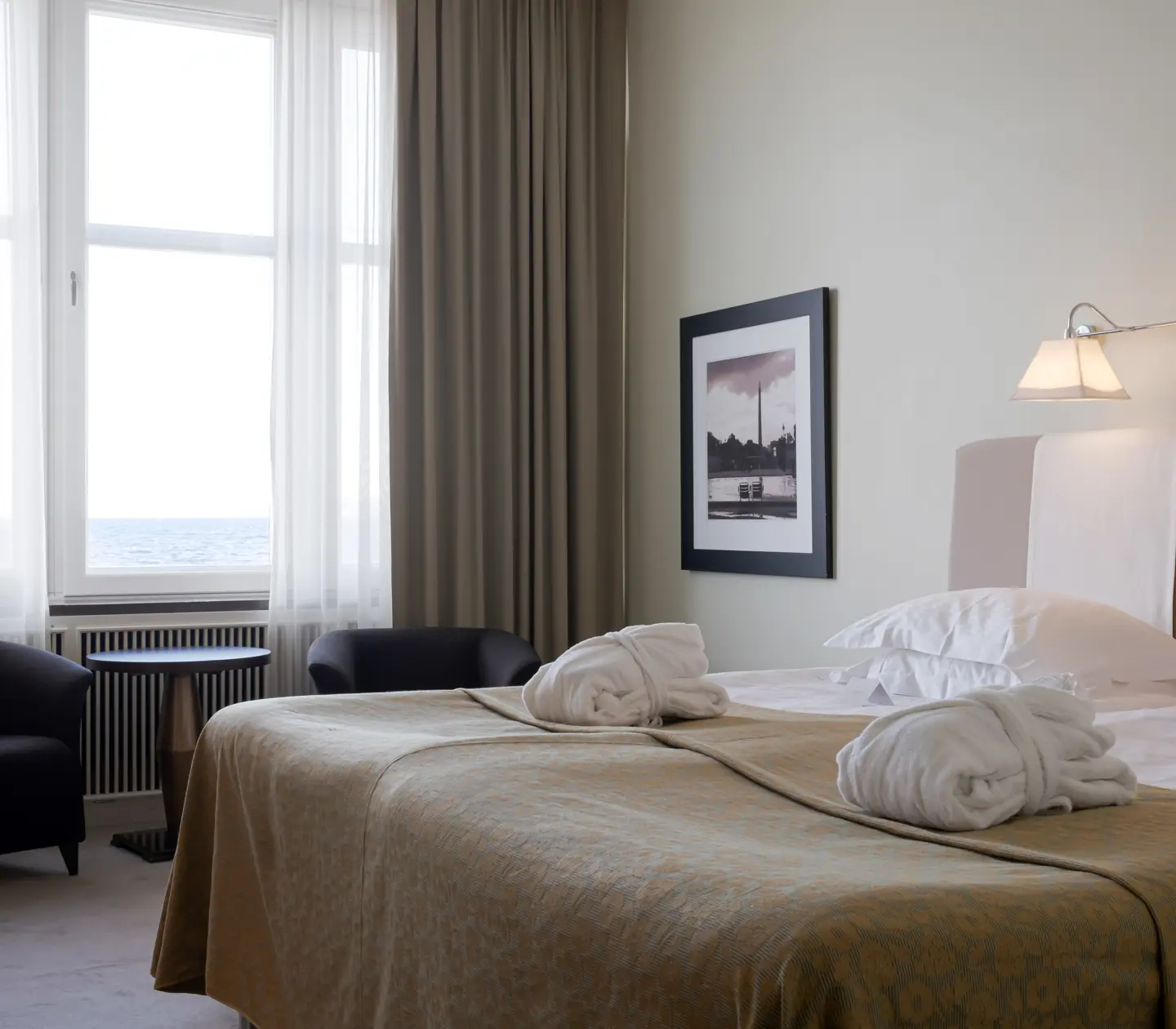 Hotel room with bed, armchairs and sea view
