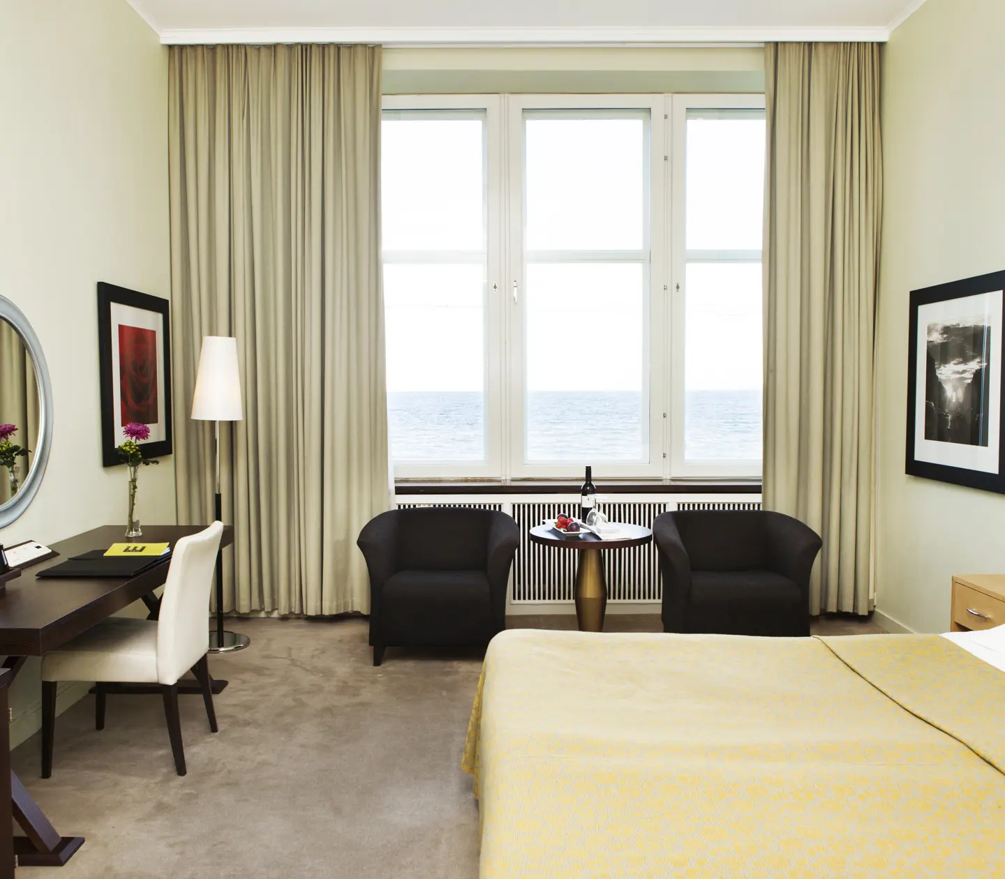 Hotel room with bed, armchairs and sea view