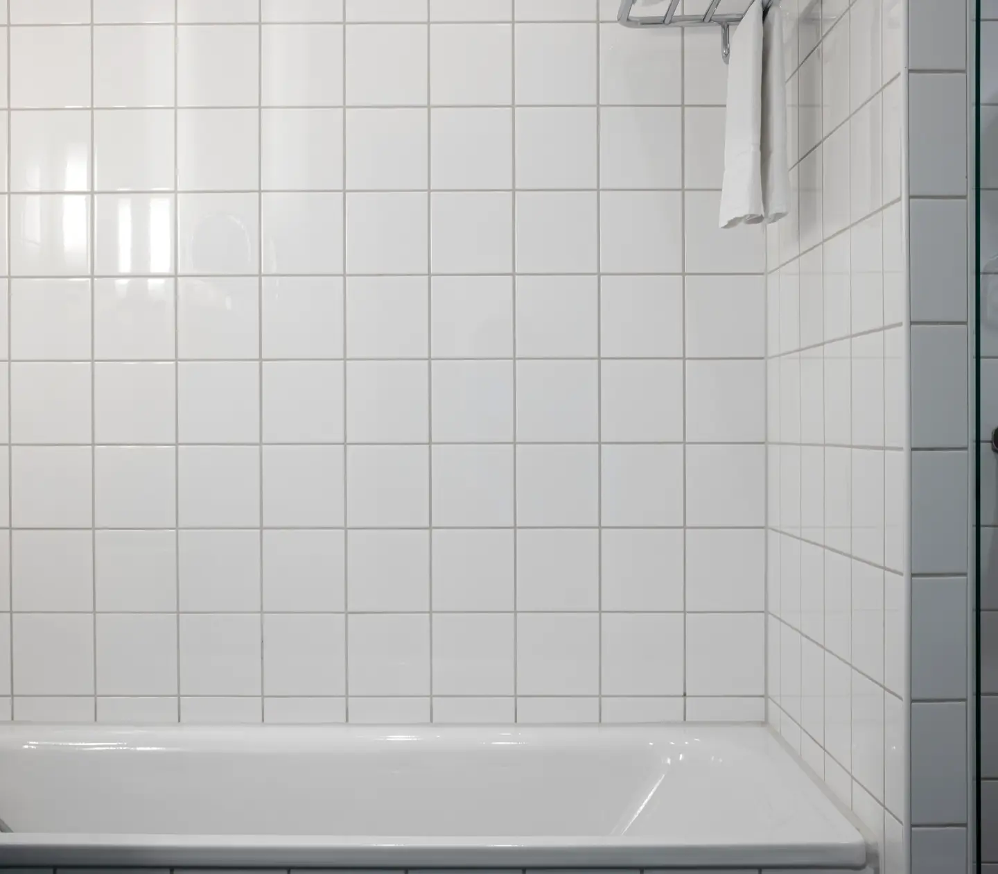 Bright bathroom with bathtub, shower and towels