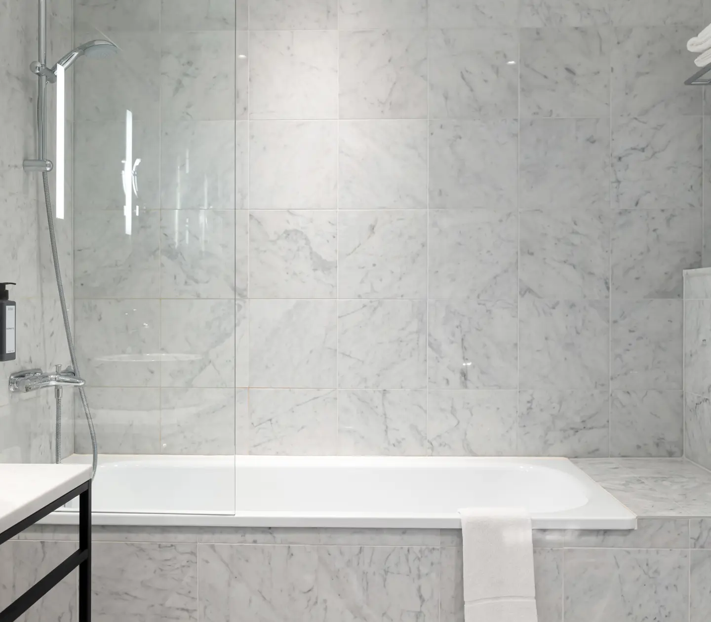 Bright bathroom with bathtub, shower and sink