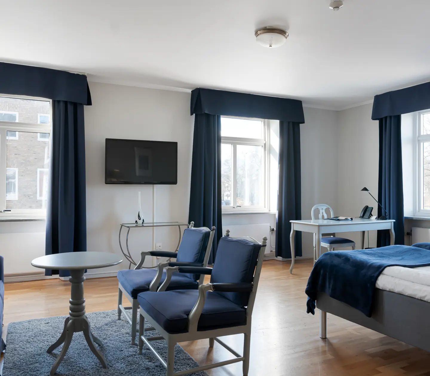 Hotel room with sitting area and desk and window