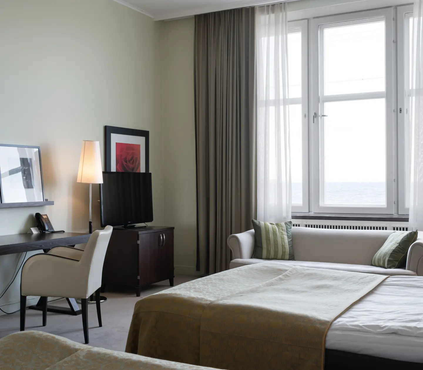Hotel rooms with beds, desks and windows