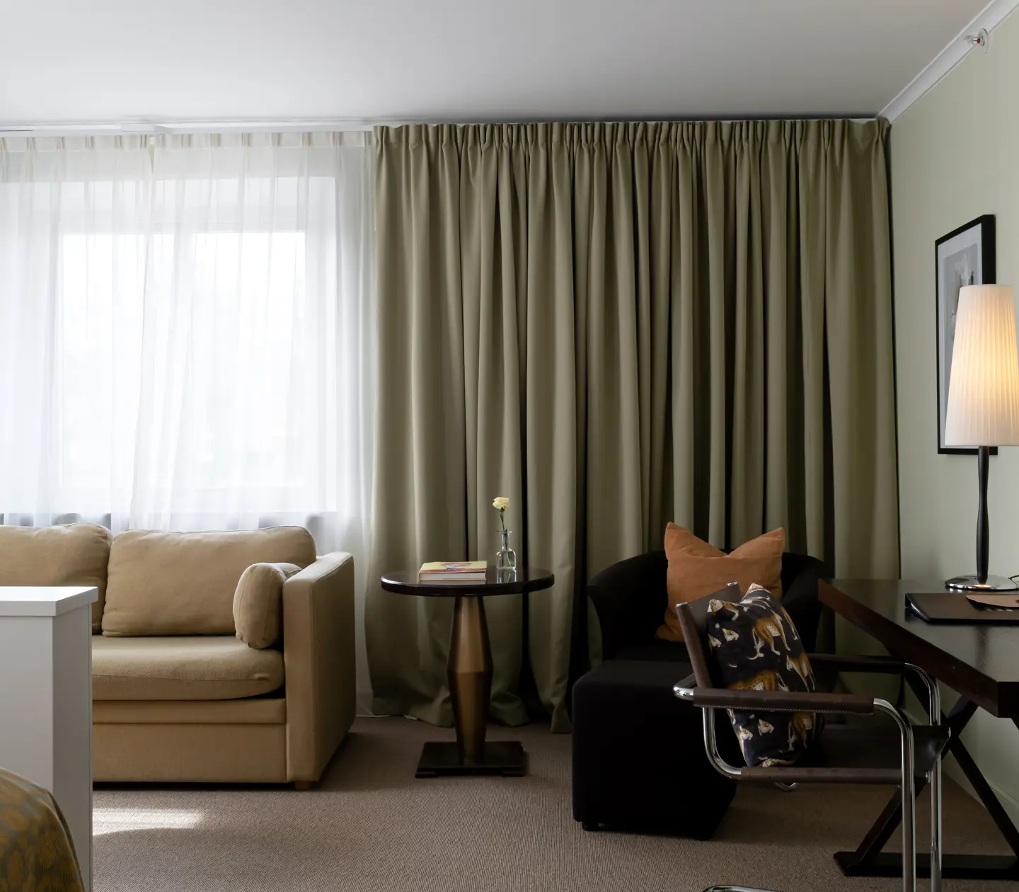 Suite with desk, seating area and large windows