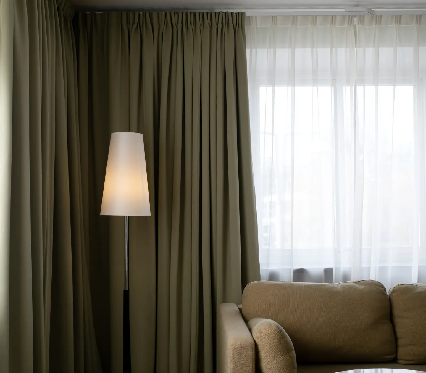 Suite with sofa, floor lamp and large window