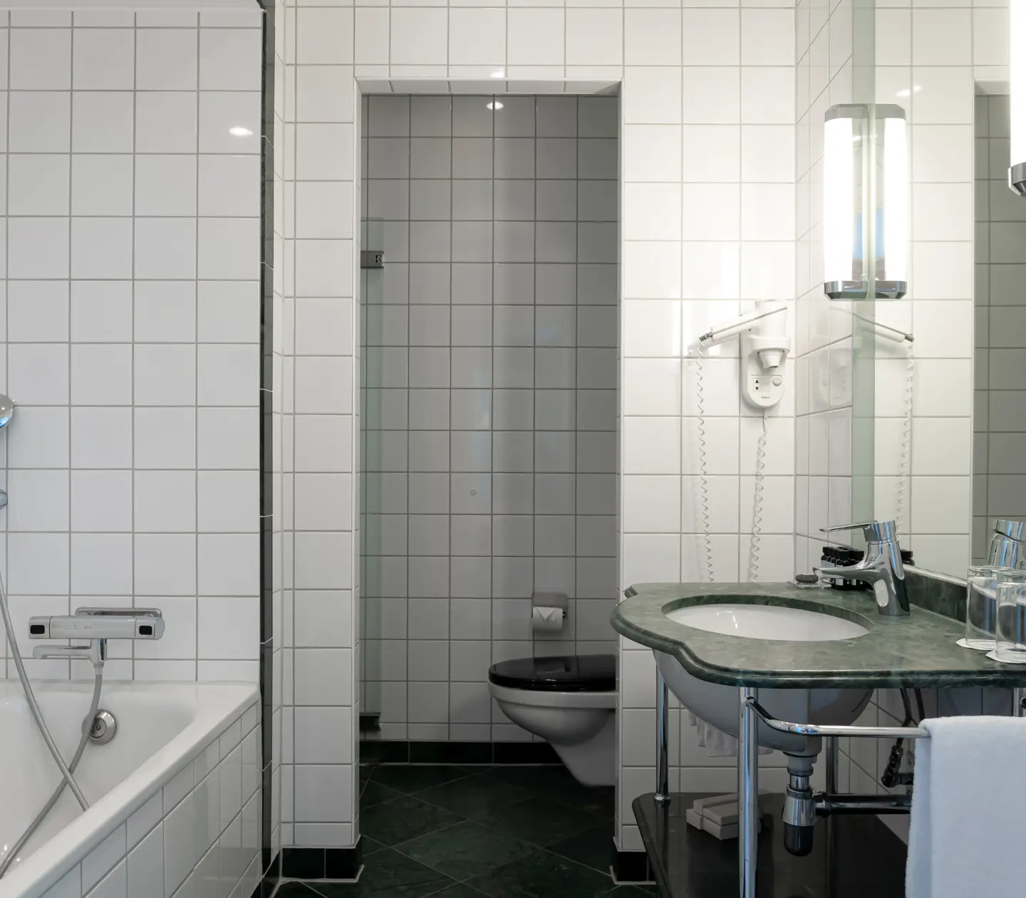 Bright bathroom with bathtub, toilet and sink