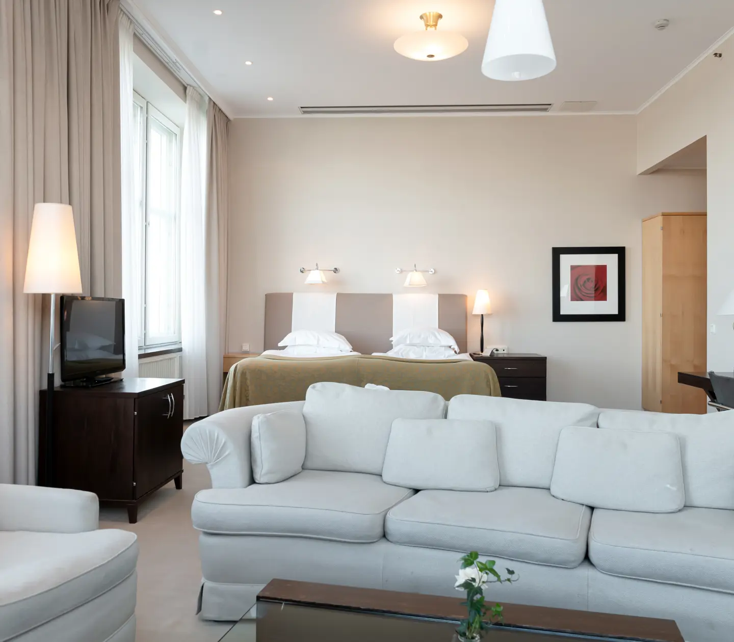 Suite with bed, seating area and desk
