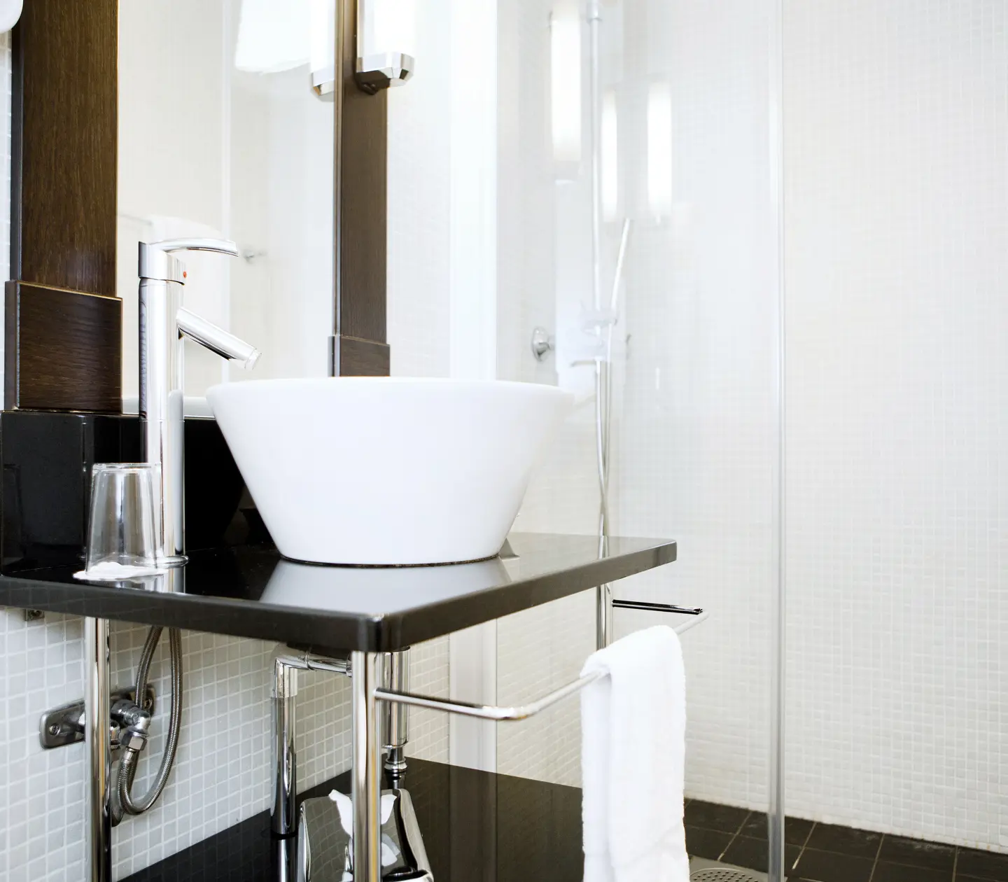 Bright bathroom with shower, sink and mirror