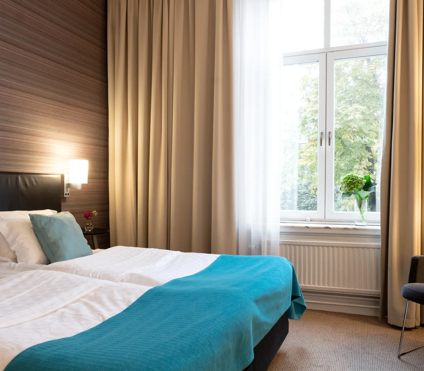 Hotel room with double bed, armchair and window