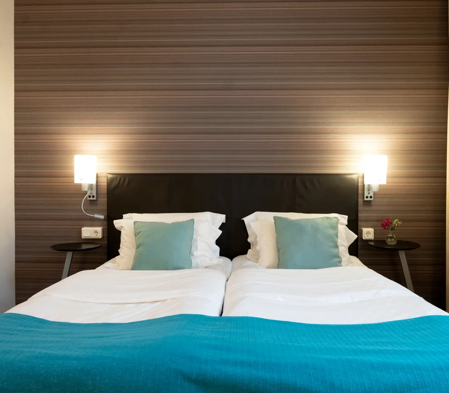 Hotel room with double bed, blackboard and bedside lamps