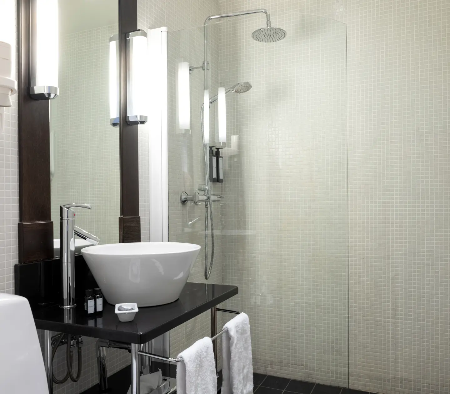 Bright bathroom with shower, sink and toilet