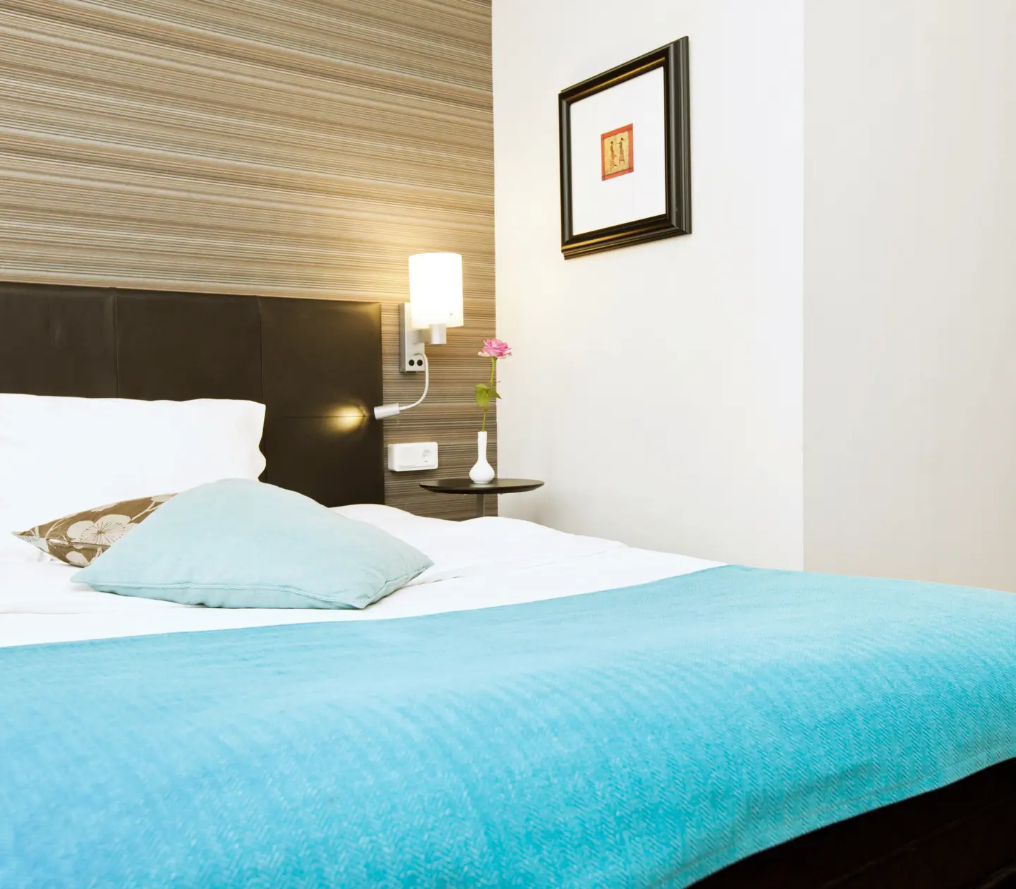 Hotel room with double bed, blackboard and bedside lamp