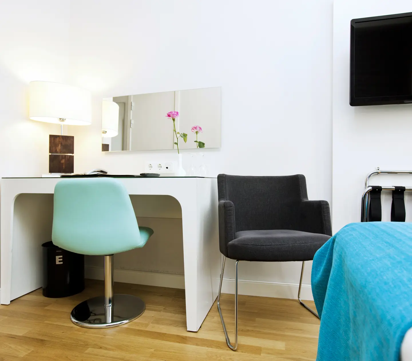 Hotel room with desk, mirror and TV