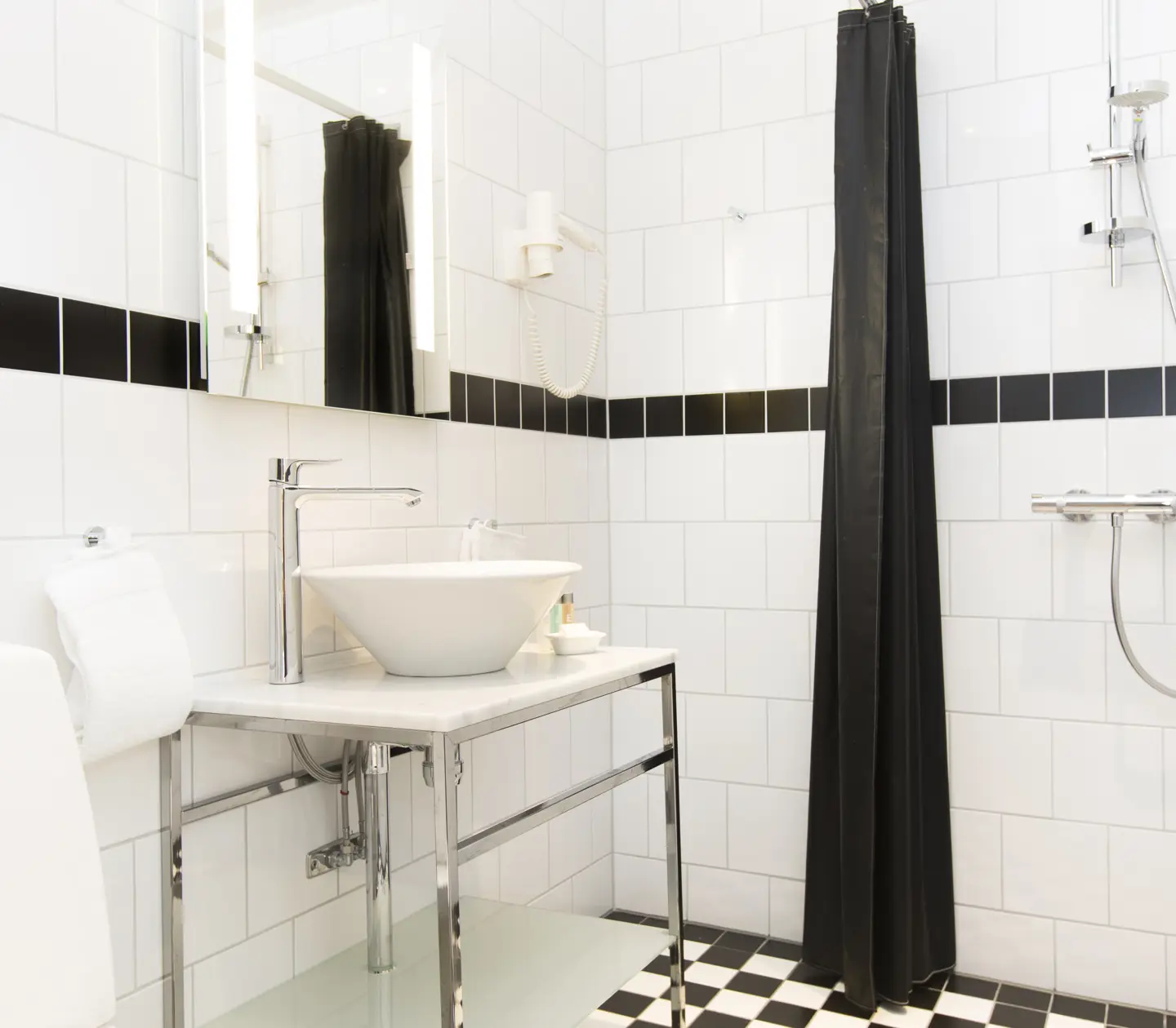 Bright bathroom with shower, sink and toilet