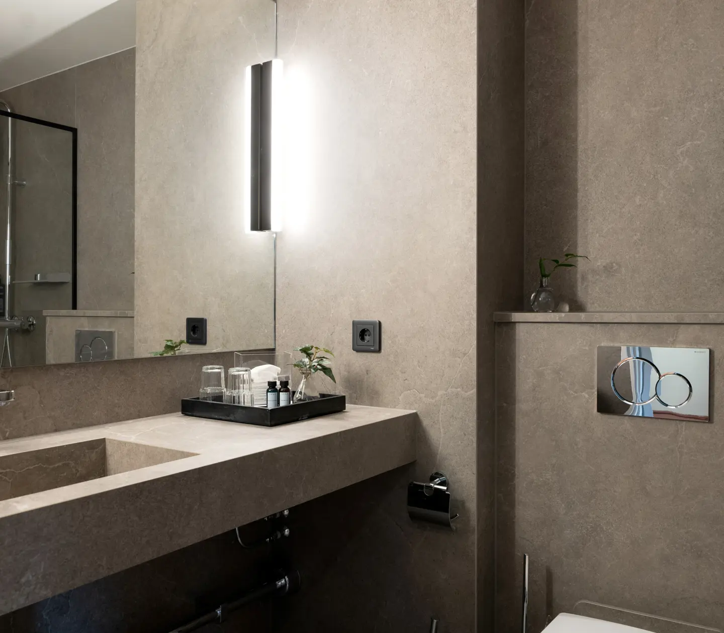 Beige-brown bathroom with toilet, sink and mirror
