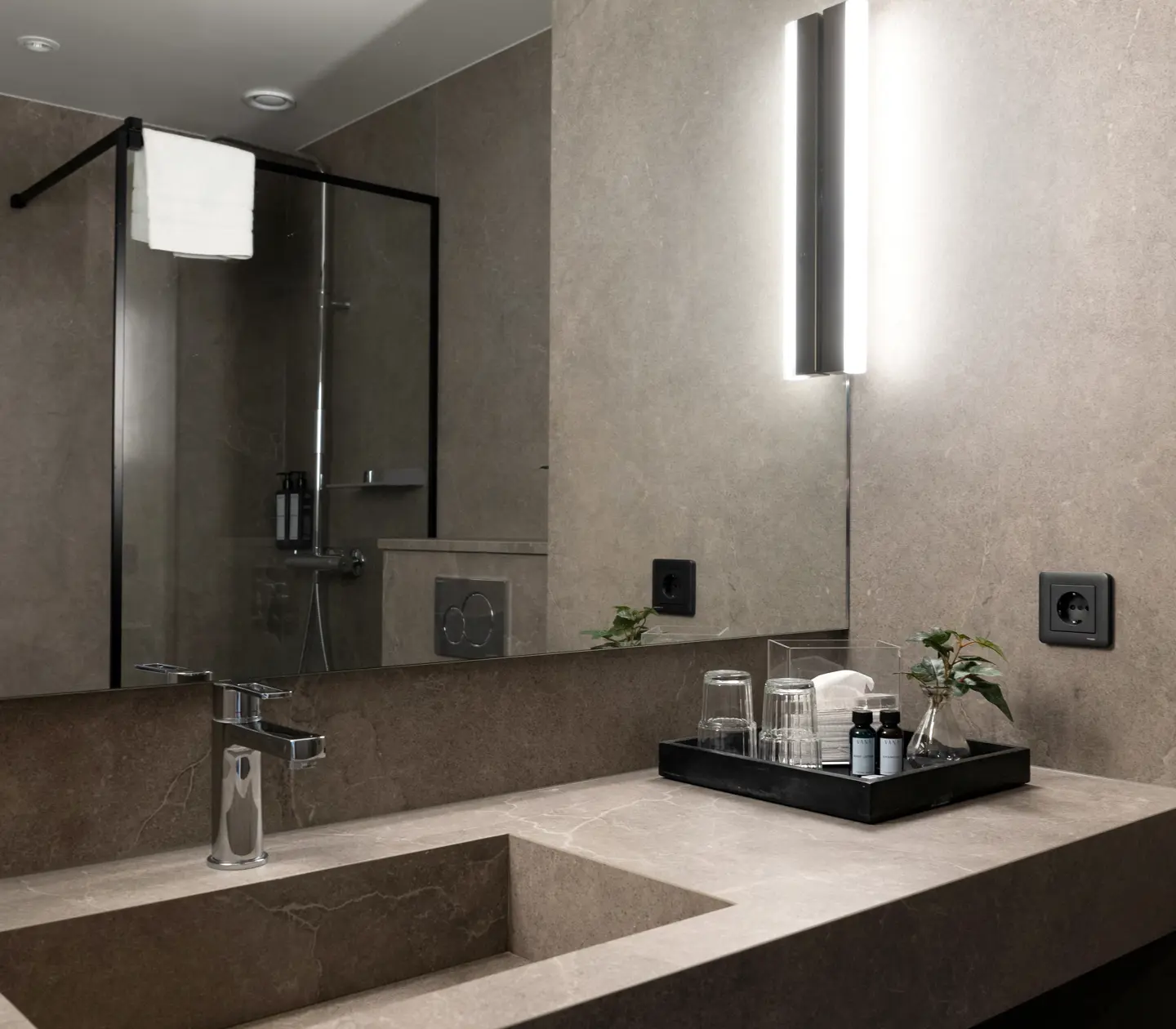 Beige-brown bathroom with sink, mirror and plants
