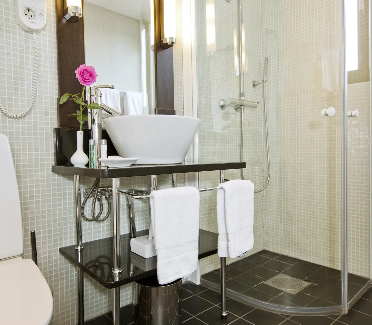 Bright bathroom with sink, toilet and shower