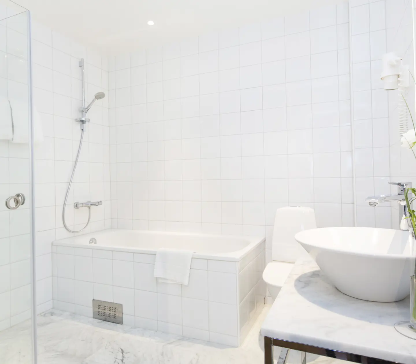Bright bathroom with sink, toilet and bathtub