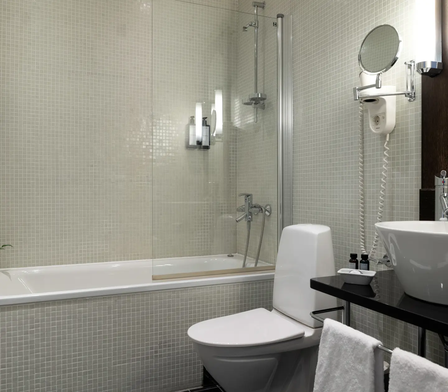 Bright bathroom with sink, toilet and bathtub
