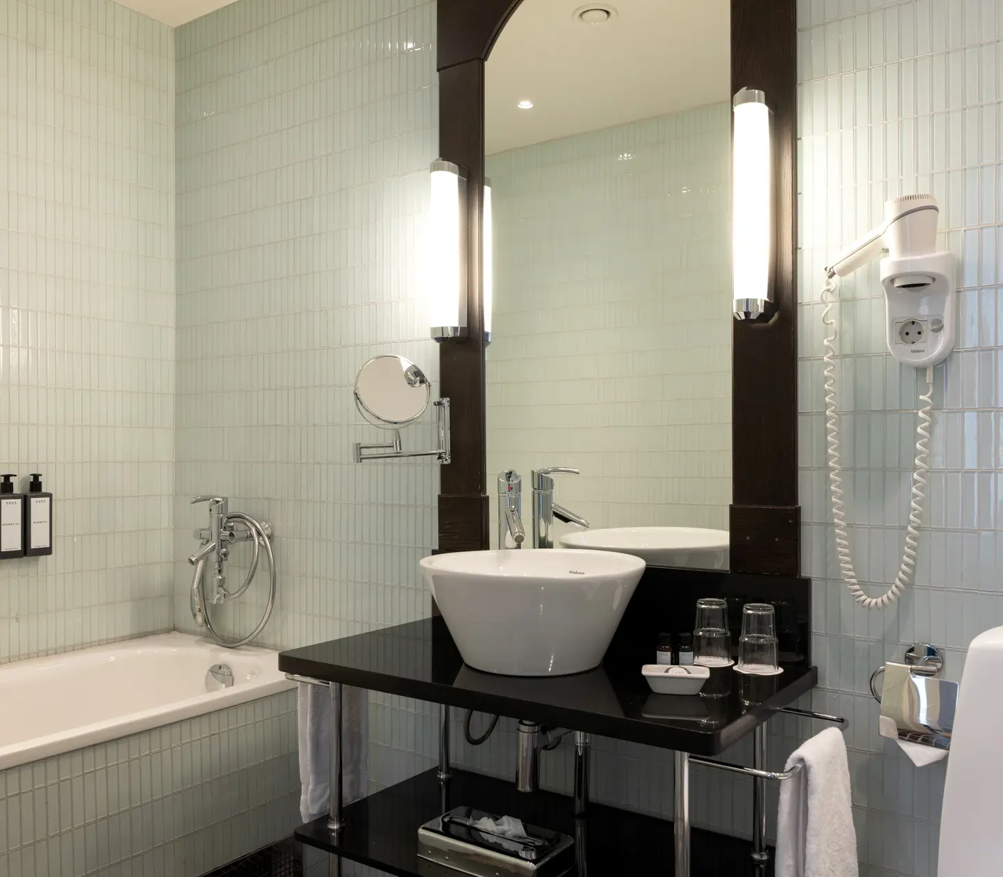 Bright bathroom with sink, toilet and bathtub