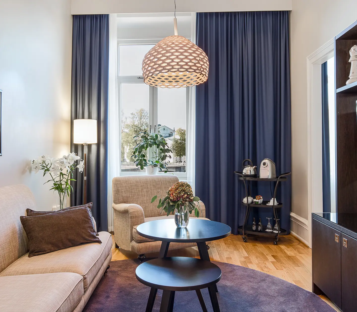 Bright suite with sofa group, TV and window