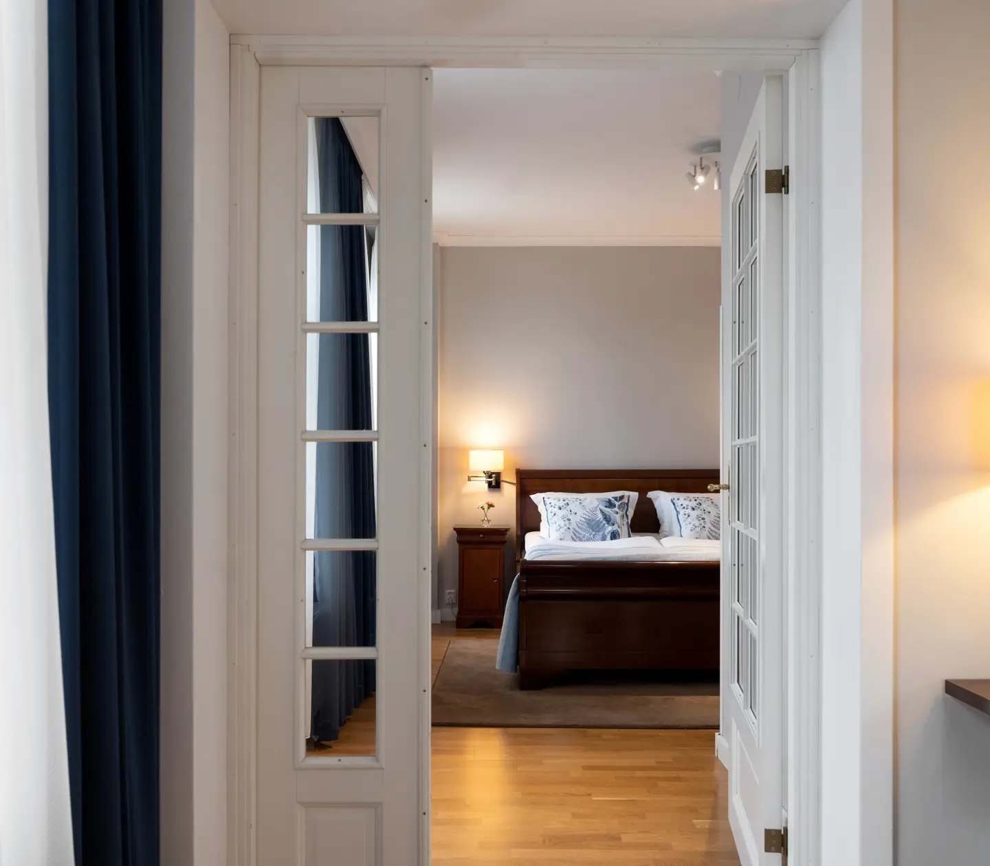 Bright suite with glass doors to bedroom and double bed